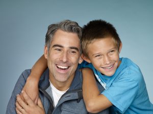 Nicholas and Doug, smiling and looking off camera.